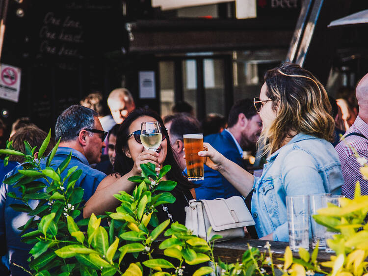 Women drinking in a garden.