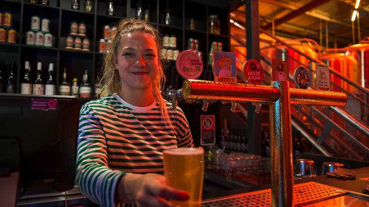 Person pouring beer at Yullis Brews