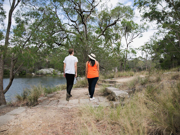 A couple walking around Lake Parramatta