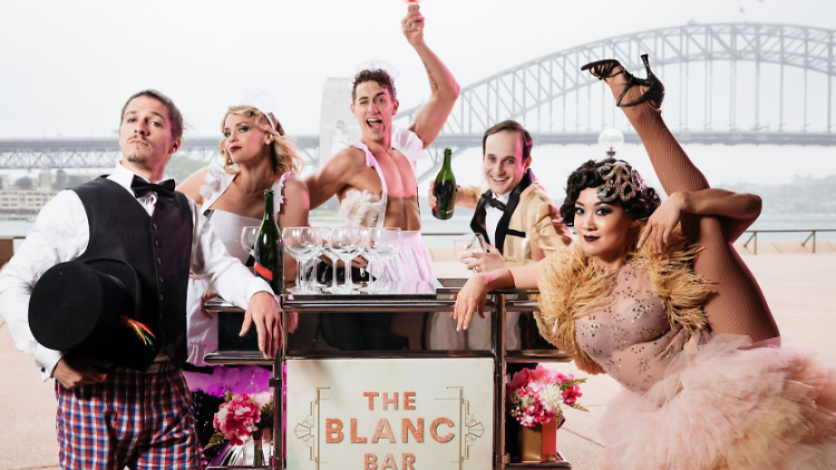 Actors posing in front of the Sydney Harbour Bridge.