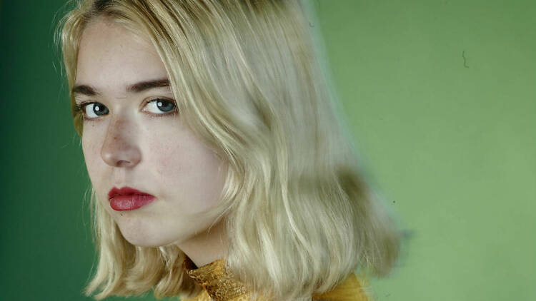 Snail Mail's Lindsey Jordan in front of a green background