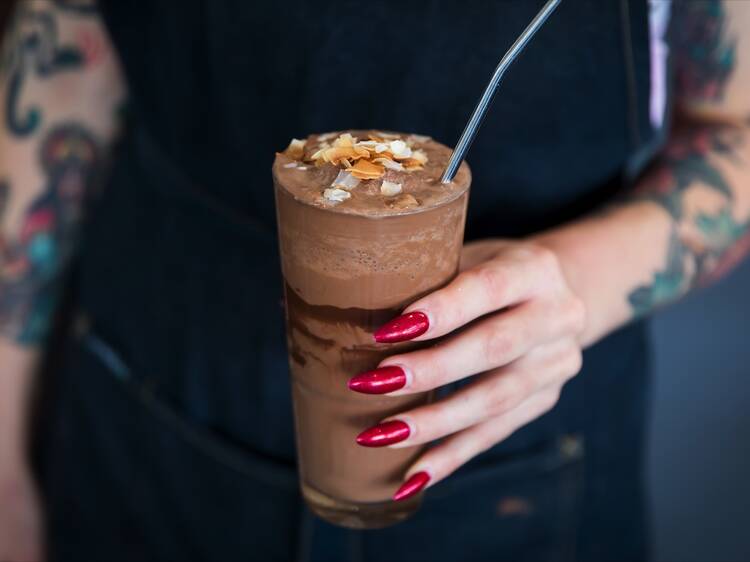 Person holding a milkshake at Matinee Coffee