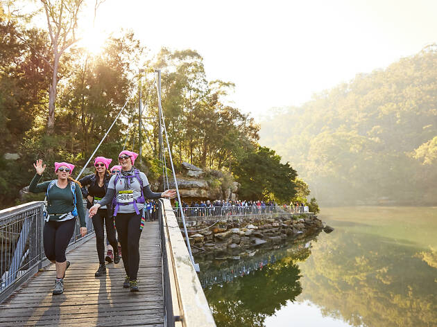 Oxfam Trailwalker People walking over a bridge.