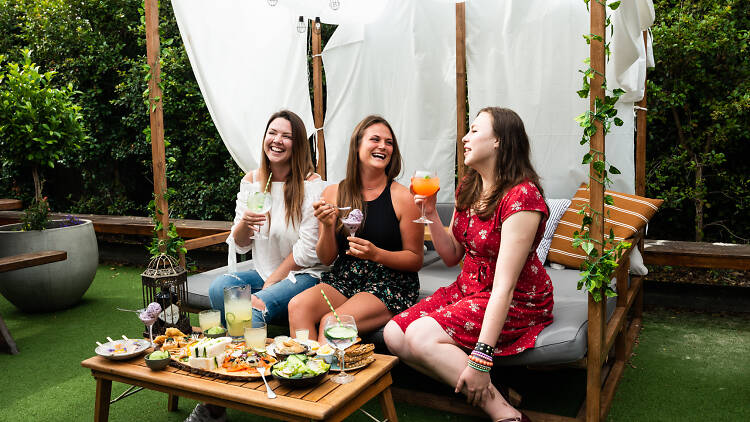 Women drinking at The Auburn Hotel's gin garden