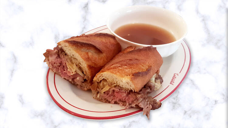 A roast beef sandwich with broth