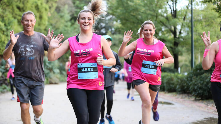 People running in a fun run dressed in pink.