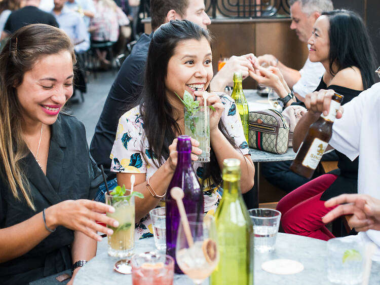 People enjoying drinks at Long Chim's Happy Happy Hour