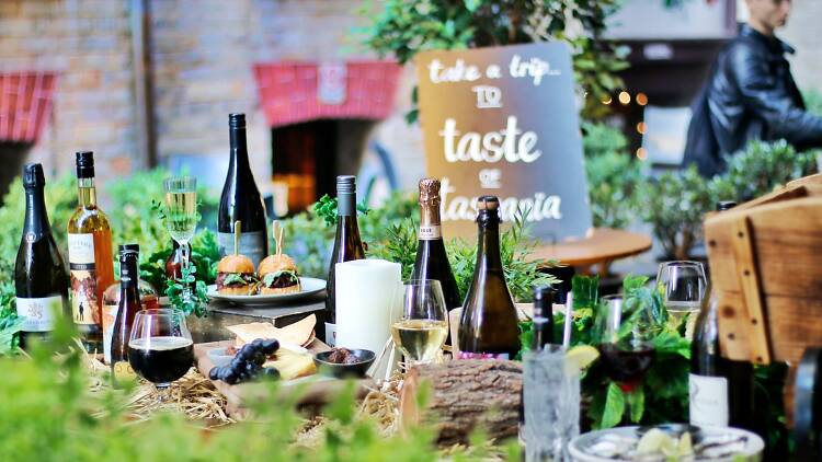 Taste of Tasmania Laneway Cellar Door A table laid with cheese and bottles of wine