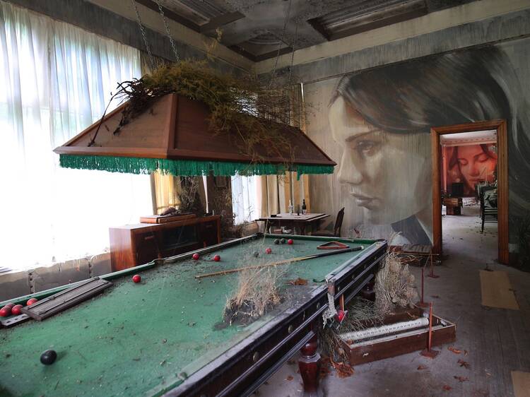 pool table Inside an abandoned house at Rone Street Art Exhibtio