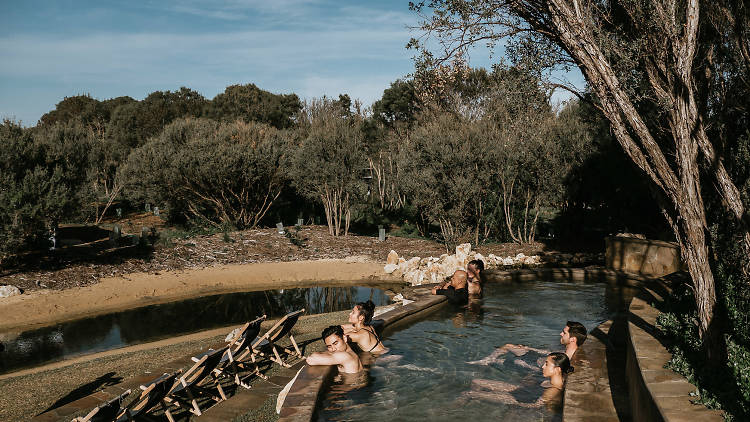 People in a pool looking at nature at Peninsula Hot Springs