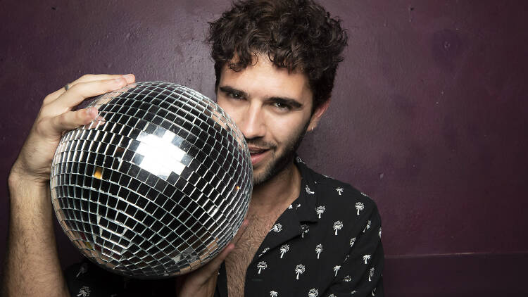 Man holding a disco ball.