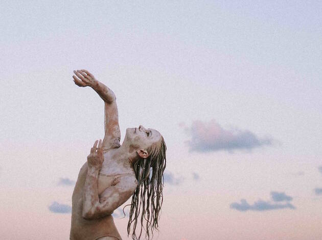 Person dancing in a leotard and body paint.