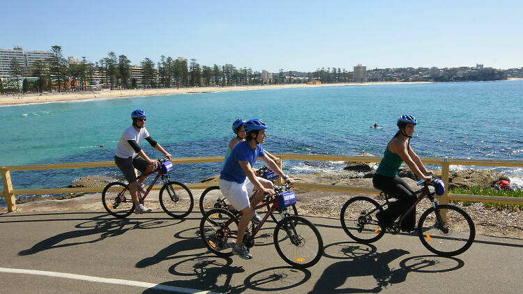 Group of people on a self-guided tour of Manly on bikes