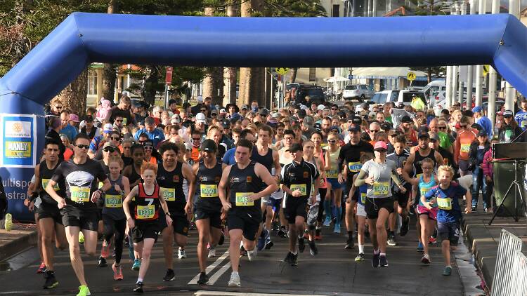 People running on a road for the manly fun run.