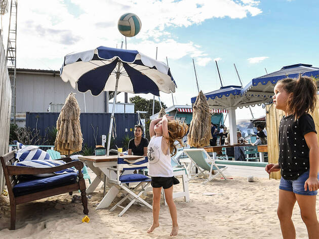 Children at COOK at Kurnell Children in the sand playing with a beach volleyball