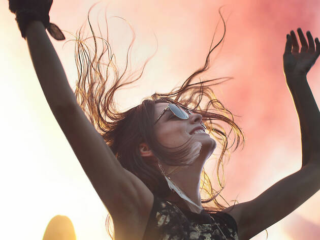 Woman dancing with her hands in the air.