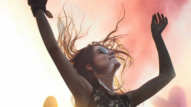 Woman dancing with her hands in the air.