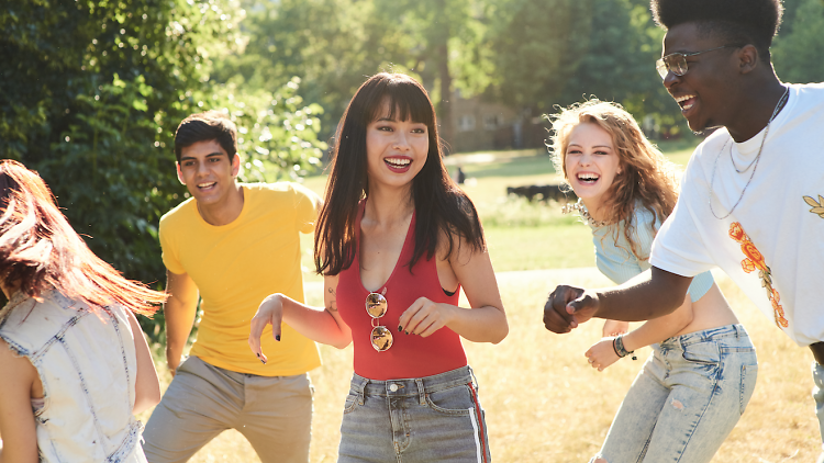 group of people laughing in a field