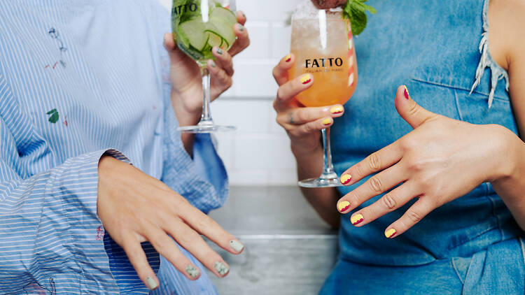 Hands with funky manicures and spritzes