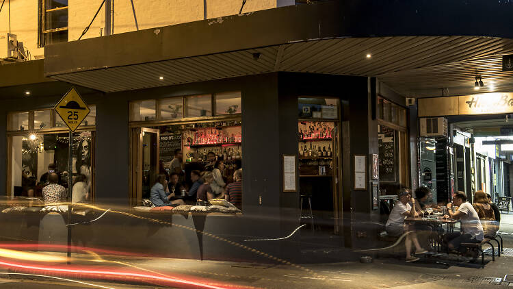 People sat at a bar at night in Erskineville