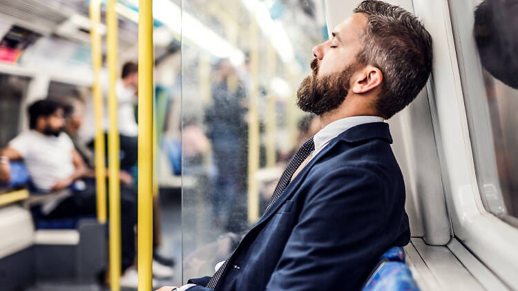 Man sleeping on London tube train