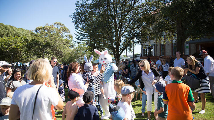 Families in the park with the Easter bunny.