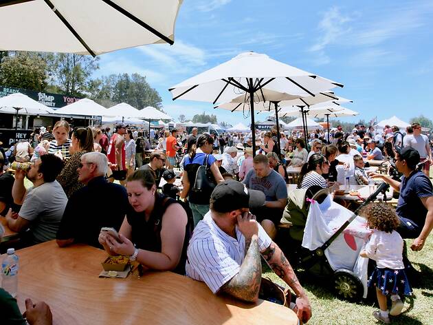 People sitting at tables at a market.