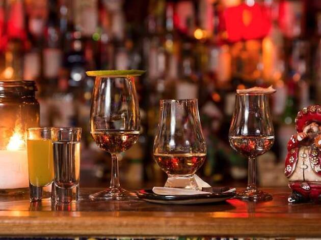 Mezcal at Tio's Agave spirits lined up in glasses along a bar