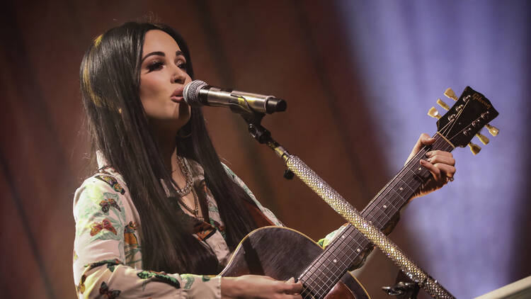 Kacey Musgraves on stage playing guitar at Palace Theatre St. Paul