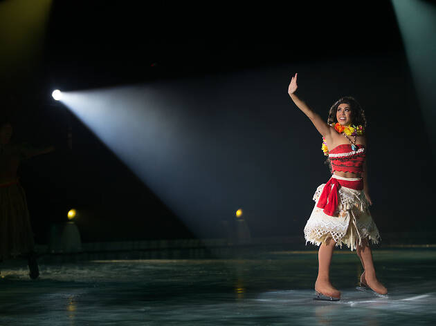 Disney on Ice Moana Actor dressed as Moana skating on ice.