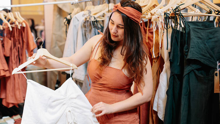 Woman in peach dress showing off white dress