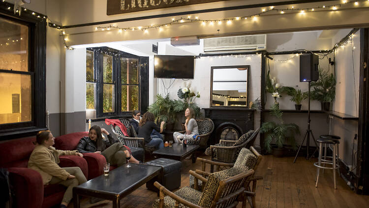 People sitting in the Old Fitz Hotel at night