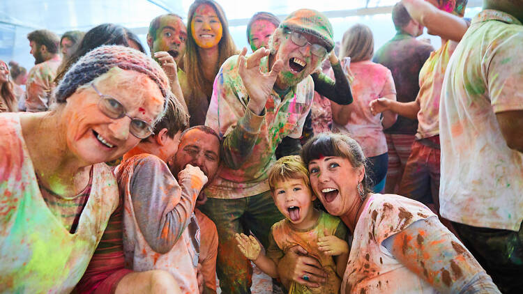 Group shot of people covered in coloured powder