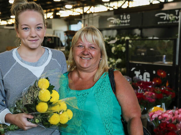 Sydney Flower Market - edit of original image to fit feature package Two women holding flowers at the flower market.