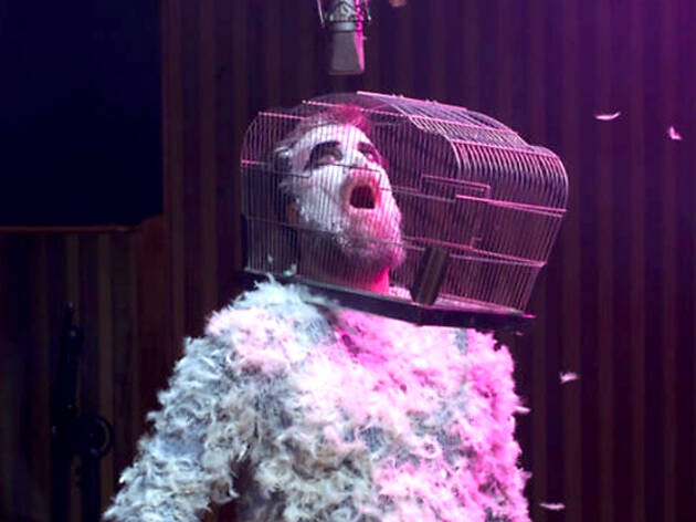 John Grant, 'Love Is Magic' 2018 album cover Person with gage on head, covered in feathers, John Grant, 'Love Is Magic' 2018 album cover