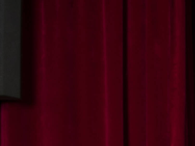 Marlena Dali and Porcelain Alice wearing crowns and pearl costumes standing in front of a red velvet curtain from the Oyster Club in Chippendale