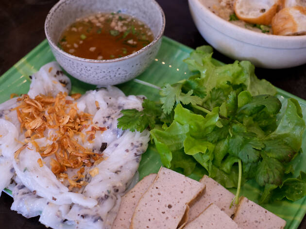 Banh Cuon Ba Oanh A platter of steamed rice noodles, herbs, sauce and meat
