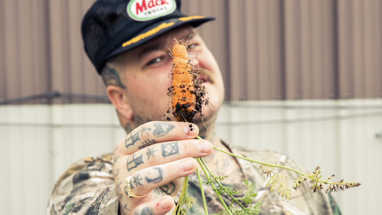 The celebrity chef holding up a freshly unearthed carrot