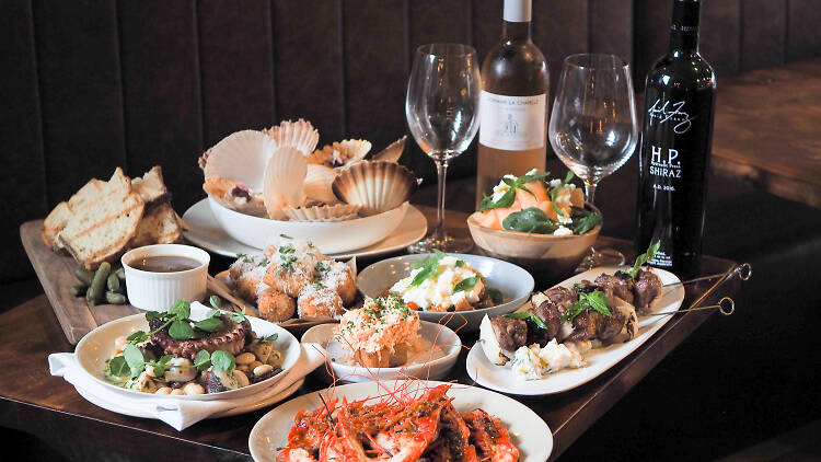 A selection of share plates and bottles of wine