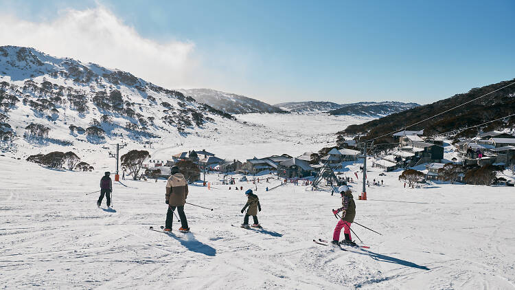 Family enjoying a day of skiing at Charlotte Pass Ski Resort in the Snowy Mountains.