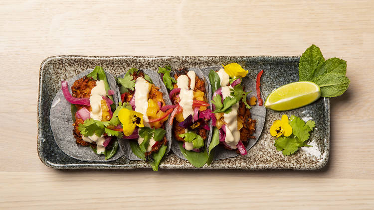 Tacos of blue corn with 'conchinita pibil' at Stem + Glory