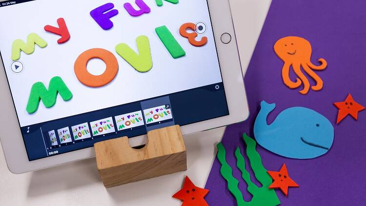A child's sleeve with animated animals on it in front of a white piece of paper that spells out "My fun movie".