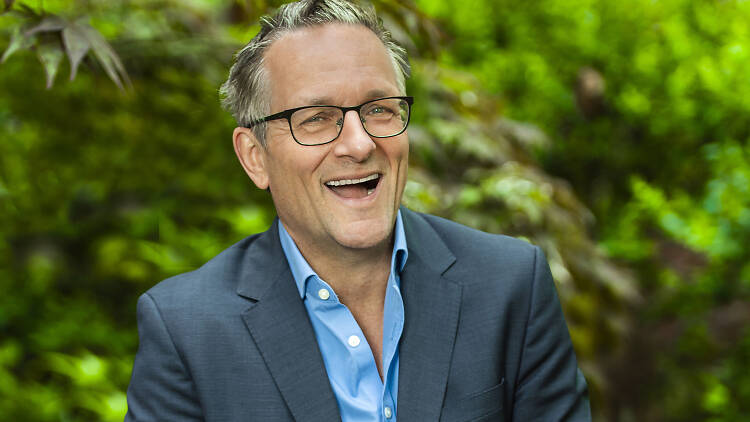 Michael Mosley smiling in front of some trees.