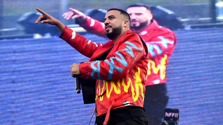 Rapper French Montana performing onstage in front of a video screen.