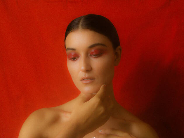 Milan Ring Singer-songwriter Milan Ring poses in front of a red backdrop.
