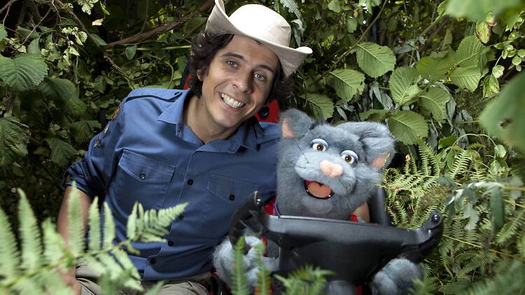 Andy and a puppet in a tree for Andy's Wild Adventures TV show.