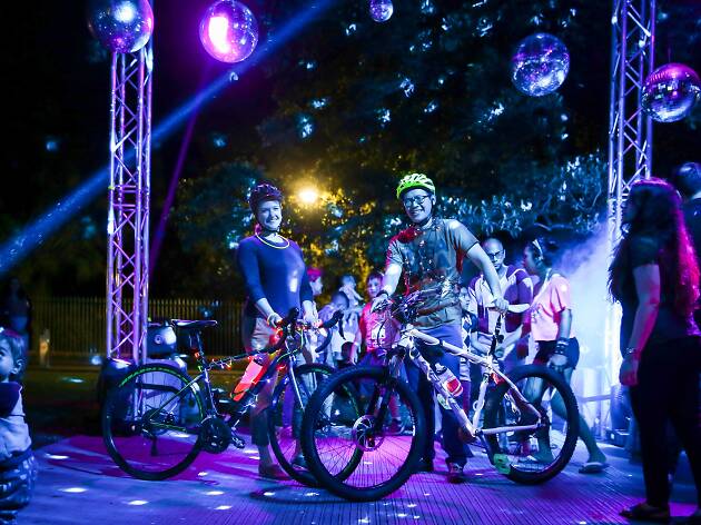 Light the City Bike riders and their bikes at the silent disco stage at the Sydney Rides festival.
