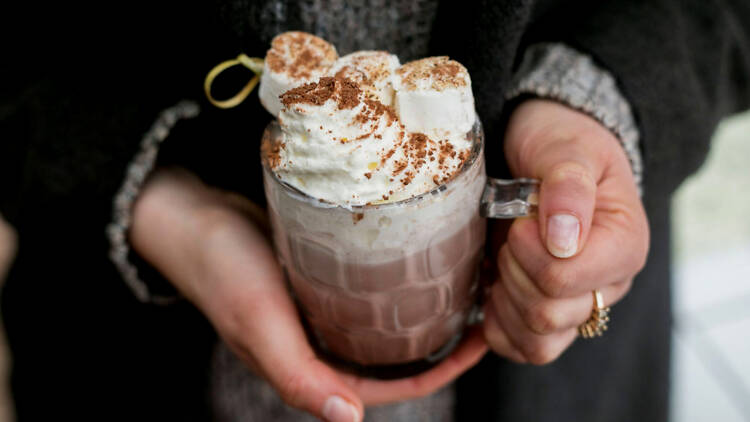 Close up shot of boozy hot milo in a mug,  topped with marshmallows