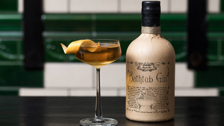A cocktail next to a bottle of Ableforth's Bathtub Gin.
