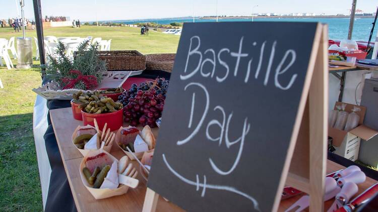 Bastille Day at La Perouse Bastille Day sign and snacks on a table at La Perouse.